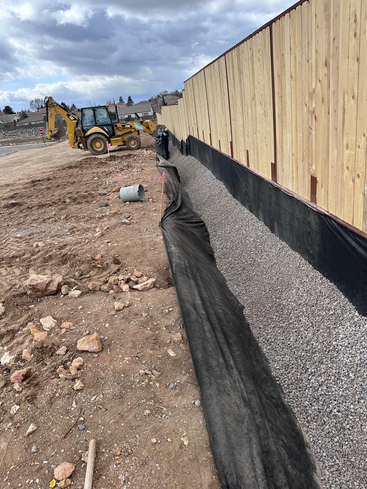 Exterior grading and fence construction in progress